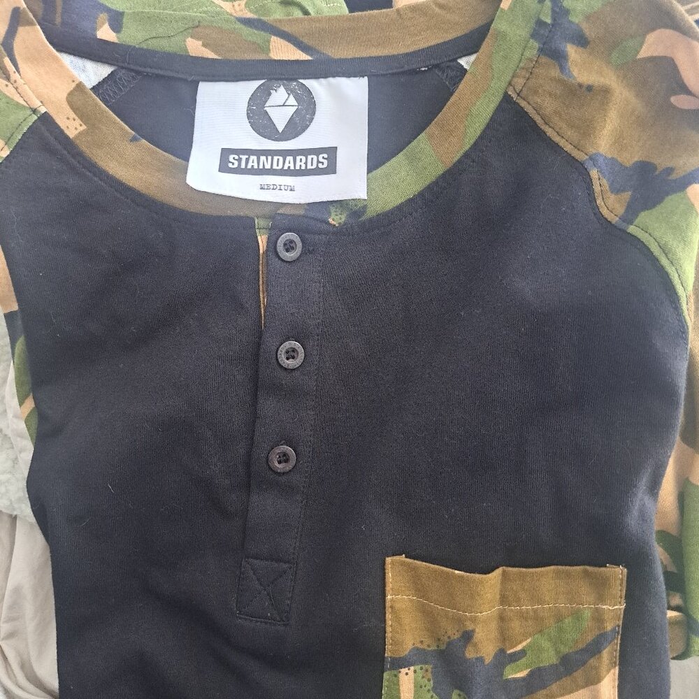 Standards brand long-sleeve Henley featuring a black body with camouflage-patter